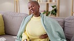 Black woman, couch and stomach with cramp, pain and rubbing for healthcare in home living room. Gen z african girl,  digestion and menstruation on sofa for health, medical or constipation in house