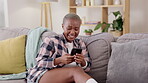 Laugh, relax and phone with black woman on sofa streaming, social media and funny post. Technology, internet and app with girl scrolling in living room at home for text message, browsing and search