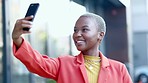 Travel, happy and black woman taking a selfie in the city while walking in the street on vacation. Happiness, adventure and African female taking a picture on a phone while on walk in town on holiday