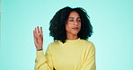 Hand gesture, annoyed and talking with a black woman in studio on a blue background feeling frustrated. Hands, frustration and ignoring with an attractive young female looking moody or uninterested
