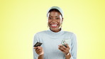 Phone, credit card and face of a black woman in a studio doing online shopping for sale or discount. Happy, smile and African female buying from ecommerce website with cellphone by yellow background.