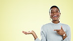 Happy, mock up and presentation with a black woman in studio on a yellow background for product marketing. Smile, mockup and space with an attractive young female showing placement for advertising