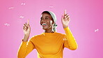 Bubbles, color and happy black woman in studio for positive attitude, happiness and glamour. Fashion, beauty and excited girl pop soap bubble with cosmetics, makeup and wellness on bright background