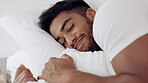 Face of happy man sleeping in bed, morning and at home for relaxing wellness, comfortable pillow and healthy rest. Young guy asleep in bedroom with smile, happiness and peaceful dreams on mattress