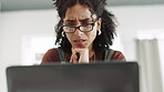 Laptop, stress and doubt with a business woman in her office, reading an email while feeling confused. Computer, glasses and worry with a female employee thinking while typing a proposal at work