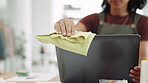 Covid, rag and a business black woman cleaning her computer in the office at work for disinfection. Hand, hygiene or sanitizer with a female employee wiping a desktop monitor for health regulations