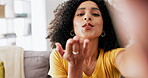 Kiss, peace sign and video call with black woman in living room for blog, social media and connection. Happy, hello and communication with girl vlogger at home for app, chatting and live streaming