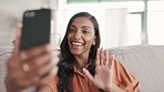 Woman, phone and video call waving with smile on living room sofa for conversation, discussion or greeting at home. Happy female talking on smartphone app in virtual chat or networking on couch