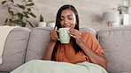 Relax, coffee and Indian woman on couch, peace and resting on break, happiness and calm in living room. Female, tea or happy lady with smile, joyful or gratitude with natural aroma, sofa or self care