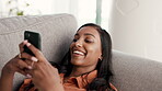 Woman, phone and smile chatting on living room sofa for communication, texting or social media at home. Happy female relaxing on couch smiling or typing on smartphone for networking, browsing or chat