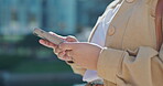 Woman, hands and phone typing in the city for communication, chatting or social media outdoors. Hand of businesswoman on smartphone texting, research or mobile app for chat or browsing in urban town