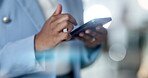 Woman, hands and typing on cellphone in night office, online notification and reading business app. Closeup worker, overtime and smartphone technology for social media, network connection and contact