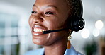 Face, call center and customer support with a black woman consultant speaking over a headset in her office. Smile, contact us and service with an attractive young female consulting closeup at work