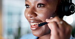 Face, call center and customer service with a black woman consultant speaking over a headset in her office. Smile, contact us and support with an attractive young female consulting closeup at work