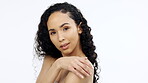 Face, beauty and skincare with a model black woman touching her shoulder in studio on a gray background. Portrait, skin and sensual with an attractive young female feeling her smooth or soft body