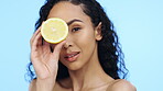 Lemon beauty, skincare and face of woman in studio, clean wellness or blue background. Model, portrait and citrus fruits for facial cosmetics, vitamin c aesthetic or healthy natural detox dermatology