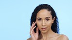 Skincare, woman and touch face on blue background, mockup and wellness dermatology in studio. Young female model, portrait and beauty on mock up, aesthetic glow and facial transformation of cosmetics