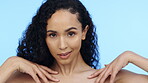 Skincare, woman and touch body on blue background, face and wellness dermatology in studio. Young female model, portrait and beauty of self love, healthy aesthetic glow and clean cosmetics results 