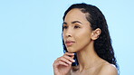 Skincare, woman and thinking face in studio for beauty, dermatology and mockup ideas on blue background. Young female model dream of cosmetics, aesthetic wellness and vision of facial transformation