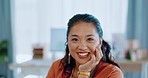 Happy, smile and face of a woman in the office while working on a creative project by her desk. Success, confidence and portrait of a professional asian female employee sitting in a modern workplace.