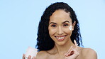 Face cream, lotion jar and beauty of woman, cosmetics and smile on blue background. Facial cream, skincare and portrait of happy model with container of sunscreen, wellness shine and aesthetic makeup