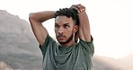 Fitness, mountain and man doing a stretching exercise before outdoor run training for race. Sports, runner and young male athlete doing arm warm up for cardio workout for marathon practice in nature.