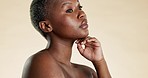 Beauty, face touch and black woman for facial treatment, wellness and cosmetics on yellow background. Dermatology, spa aesthetic and portrait of African girl with glowing skin, makeup and skincare