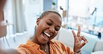 Face, selfie and black woman with peace sign, success and achievement in living room, happiness and excited. Portrait, African American female and lady with smile, v gesture an blow kiss in lounge
