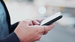 Hands, phone and texting in the city for social media, communication or online chatting. Hand of person typing on smartphone, mobile app or sms with 5G connection on a balcony of an urban town