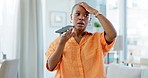 Phone call, argument and angry woman talking on a cellphone in the living room of her house. Moody, annoyed and frustrated African female fighting while on a mobile conversation at her modern home.