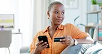 Black woman, credit card and phone for online shopping, thinking or sale on internet for smile on sofa. Retail e commerce, gen z girl or digital discount for decision, choice or cybersecurity in home