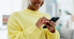 Phone, hands and black woman laughing in home, texting or typing on social media. Comic, technology or happy female with mobile smartphone for web scrolling or internet browsing for funny meme online