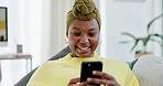 Happy, black woman on sofa and cellphone for connection, chatting and relaxing in lounge. African American female, girl and smartphone for social media, typing and laughing with joy and communication