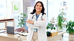 Happy asian woman, doctor and confidence with arms crossed for healthcare on office desk at hospital. Portrait of confident female medical professional standing and smiling in health advice at clinic