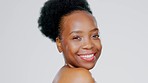 Skincare, happy and portrait of a black woman with a glow isolated on a grey studio background. Beauty, smile and face of African girl with self love, glowing treatment and cosmetic care on backdrop