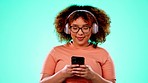 Headphones, smartphone and dancing black woman in studio with color and turquoise background with smile and happiness. Music, streaming service and dance, African person with online radio station app