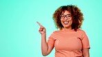 Black woman, pointing and studio mockup space with smile, excited face and comic youth by blue background. Gen z model, student and girl with mock up, product placement and nerd aesthetic for review