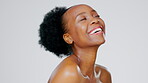 Black woman, face and happy in beauty portrait, facial and skincare glow isolated on studio background. Healthy skin, natural shine and dermatology, mockup space and cosmetic care wellness with laugh