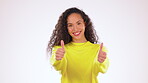 Black woman, thumbs up and smile for winning, good job or success standing isolated against a gray studio background. Portrait of happy African American female showing thumb emoji, yes sign or like