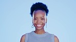 Happy, smile and face of a black woman in a studio with a confident, good and positive mindset. Happiness, excited and portrait of African female model laughing at a comic joke by a blue background.