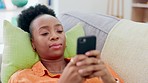 Relax, phone and black woman lying on sofa checking social media, email or message. Internet, smartphone and connect online, African person on couch typing post or text, networking and browse on app.