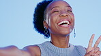 Face, selfie and black woman with peace sign and kiss in studio isolated on blue background. Laughing, smile or beauty portrait of happy female model with v hand emoji, air kissing or taking pictures