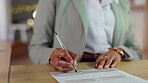 Woman, hands and writing signature for business contract, application or form at night on the office desk. Hand of female employee working late filling or signing paperwork for validation on table