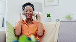 Woman dancing on couch with headphones, phone and music streaming for mental health, wellness and relaxing. African person dance on sofa and listening to audio technology on mobile app or cellphone