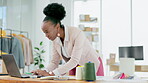 Black woman, laptop and smile for small business management in fashion or interior design at the office. Happy African American female designer working on computer in planning for color palette ideas