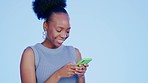 Black woman, texting and phone in studio with smile, meme or social network app for fashion by blue background. Gen z girl, smartphone or blog for funny video, communication and web chat by backdrop