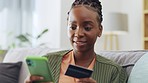 Online shopping, credit card and black woman with phone on a sofa for ecommerce, payment or banking at home. Debit, credit score and girl online for subscription, membership or budget in living room