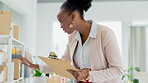 Black woman, logistics and checking boxes with clipboard for delivery, supply chain or inventory at office. Happy African female small business owner inspecting cargo or pricing of products on shelf