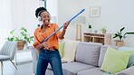 Music headphones, cleaning and black woman dance in home living room to remove dust or dirt for hygiene. Dancing, broom guitar and happy female cleaner singing while streaming radio, audio or podcast