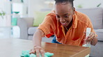 Spray, cleaning table and black woman in home living room to remove dust, dirt or bacteria for health or wellness. Maid service, cloth sanitize and happy female housekeeper with chores for hygiene.